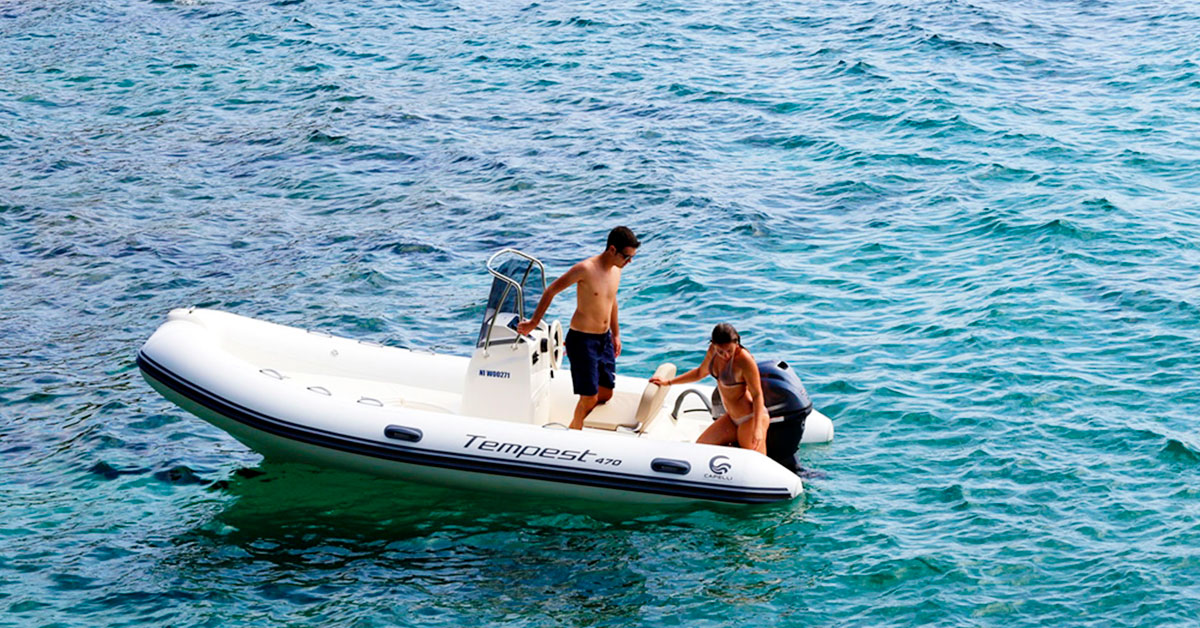 Young couple sailing in a boat without a skipper in Ibiza