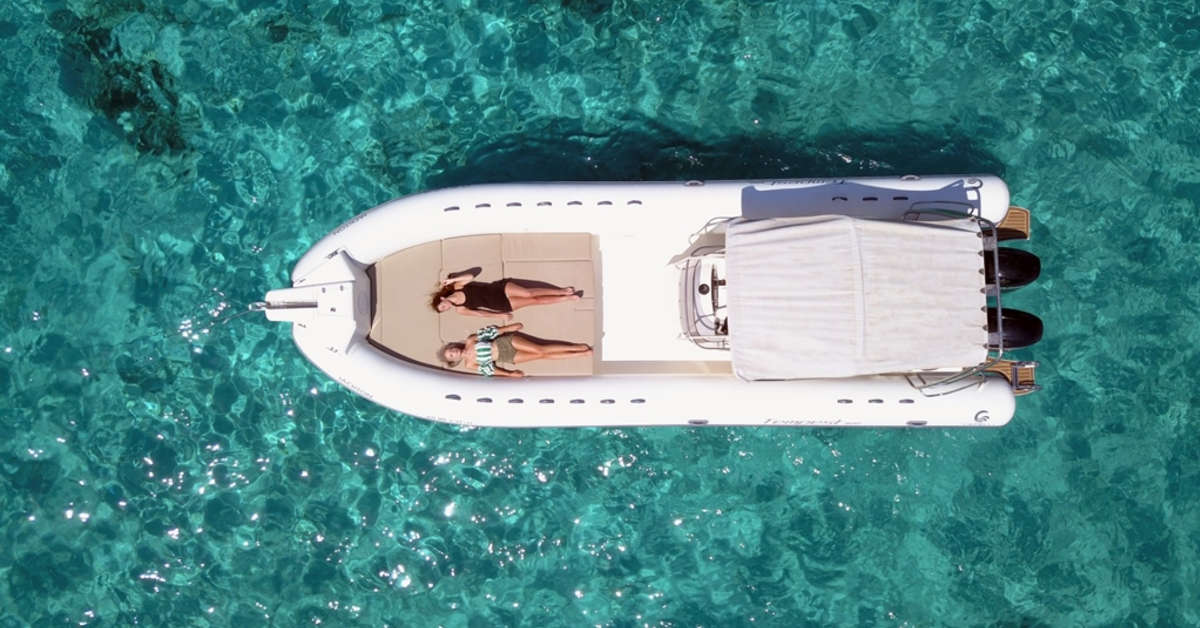 Two women sunbathe aboard a charter boat in Ibiza